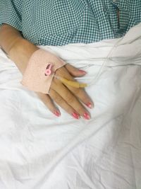 Midsection of female patient with iv drip in hospital