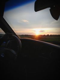 View of sunset seen through car windshield