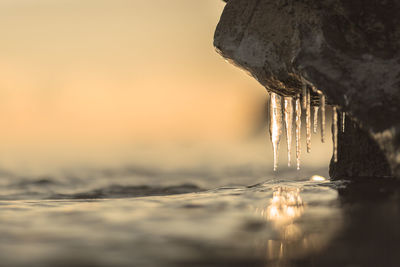 Close-up of water against sky during winter