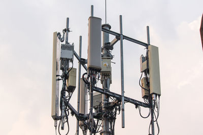 Low angle view of telephone pole against sky