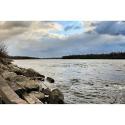 Scenic view of sea against cloudy sky