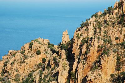 Panoramic view of sea and mountains against clear blue sky