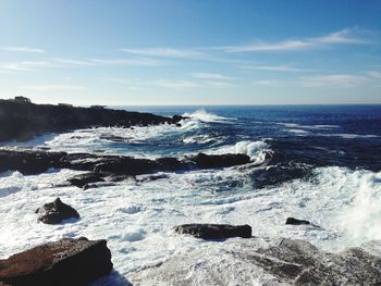Scenic view of sea against blue sky