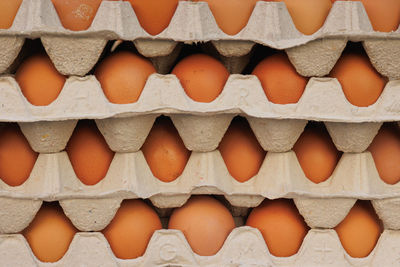 Eggs contained in their paper package arranged one on top of the other - side view.