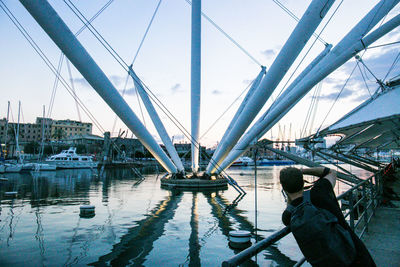 Rear view of man on bridge against sky