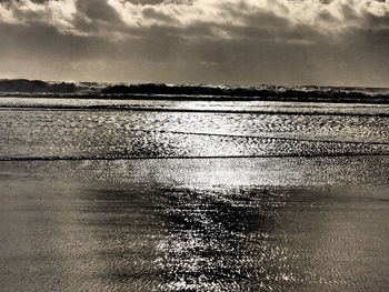 Scenic view of sea against cloudy sky