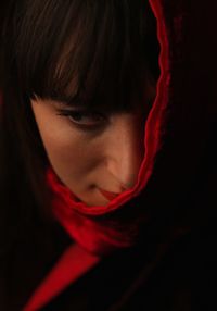 Close-up of young woman wearing red headscarf