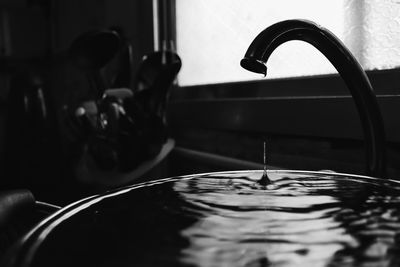 Close-up of faucet in water