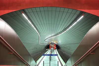 Rear view of man on escalator at subway station