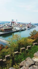 Scenic view of sea and cityscape against sky