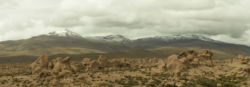 Scenic view of mountains against cloudy sky