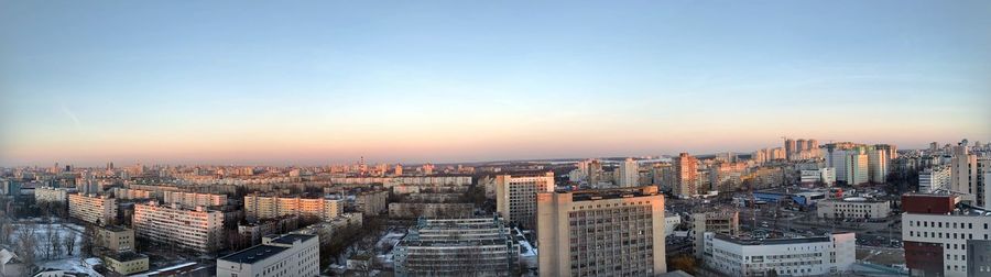 High angle view of city buildings against sky during sunset