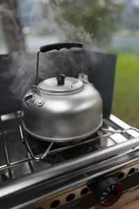 Close-up of tea cup on barbecue grill