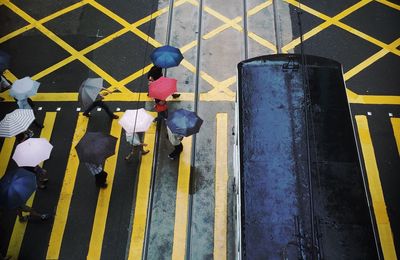 High angle view of tram and people on street during monsoon