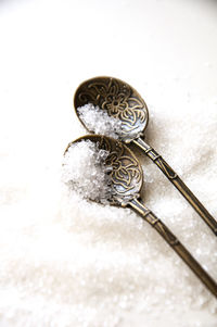High angle view of metal on table against white background