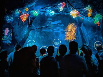 Group of people swimming in aquarium