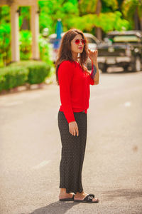 Young woman standing on road