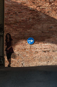 Man standing on brick wall