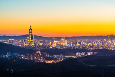 High angle view of illuminated buildings against sky during sunset