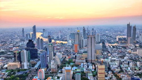 Aerial view of city buildings during sunset