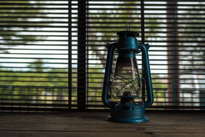 Close-up of lantern on window sill