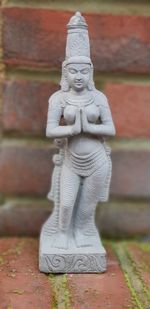 Close-up of statue against stone wall