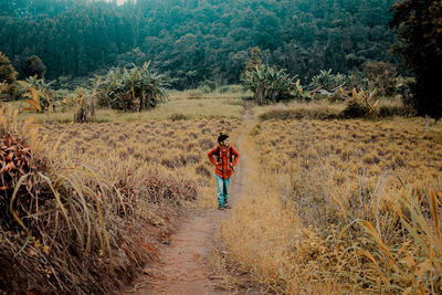 Rear view of person walking on footpath