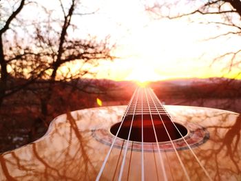 Close-up of guitar at sunset