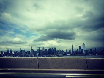 City skyline against cloudy sky