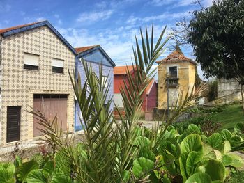 Exterior of house by building against sky