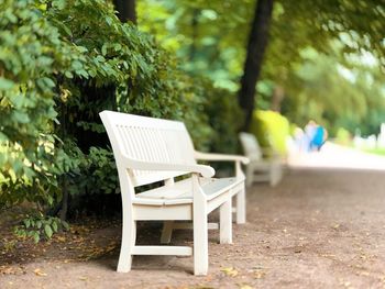 Empty chairs and table in park