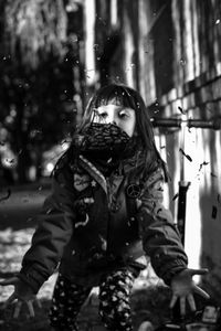 Portrait of young woman standing in park