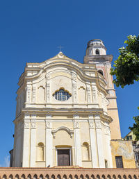 Low angle view of building against clear blue sky