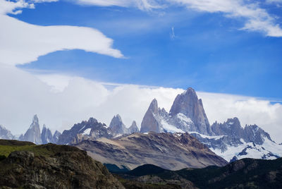 Scenic view of mountains against cloudy sky