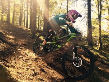 Man riding bicycle in forest