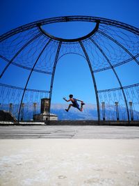 Man jumping against clear sky