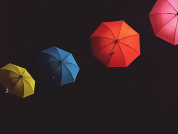 Low angle view of umbrella against black background