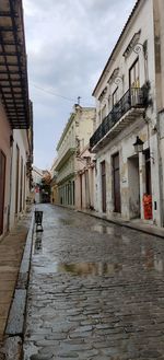 Empty alley amidst buildings in city