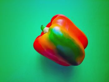 Close-up of bell peppers on green background