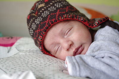 Close-up of baby sleeping on bed