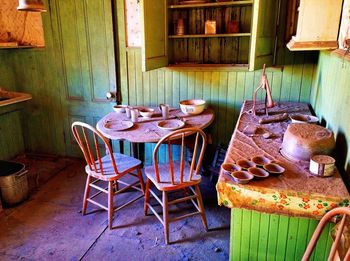 Empty chairs and table in old building