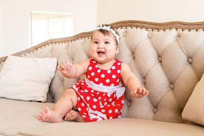 Cute baby girl on sofa