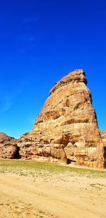 Rock formations in desert against clear blue sky