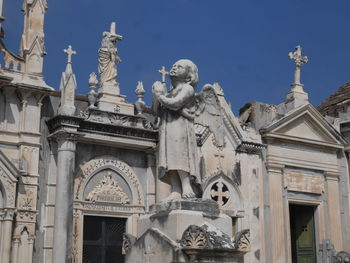 Low angle view of statue against historic building