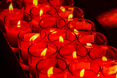Close-up of illuminated candles at temple