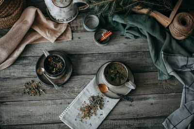 Ceramic mugs with tea on a wooden table, top view