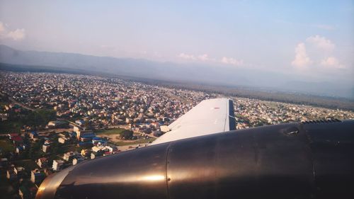 Close-up of airplane wing against sky