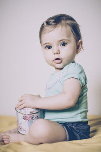 Portrait of cute girl sitting at home