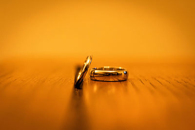 Close-up of wedding rings on orange background