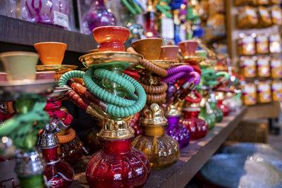 Various colorful hookahs display on souvenirs stand at market for sale